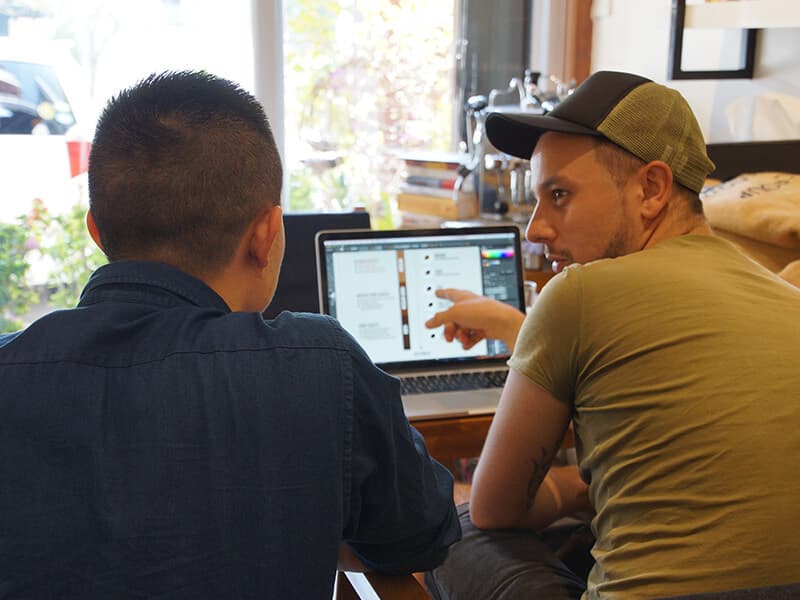 Goffee Coffee shop owner serving a customer inside the Mandalay café